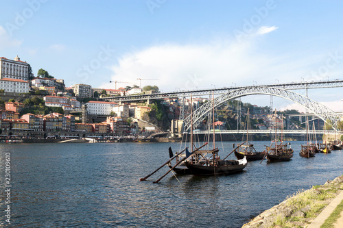 The embankment of river Douro, Porto, Portugal. Traditional Portuguese rabelo boats with wooden barrels of port on it. V © Vera