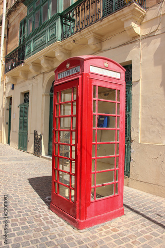 Empty telephone red booth in Marsaxlokk  Malta in sunny day