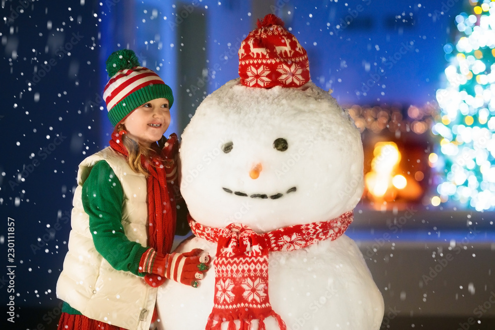 Kids and snowman in garden at Christmas fireplace. Kids and snowman in garden at Christmas fireplace.