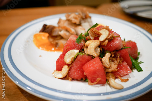 Watermelon salad with cashew nuts.