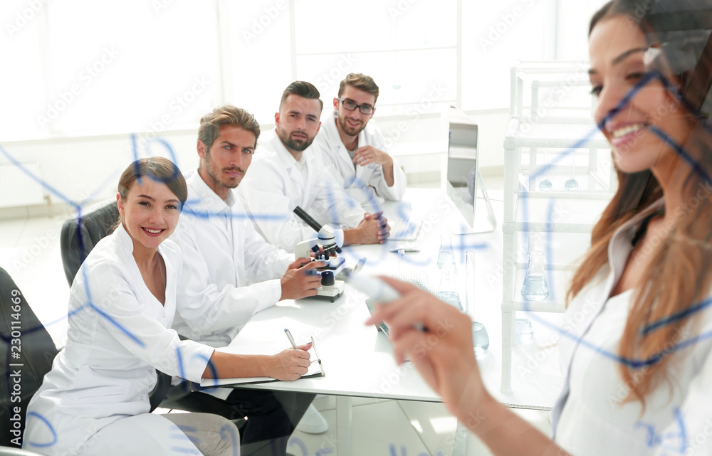 Fototapeta premium female scientist makes a report to colleagues