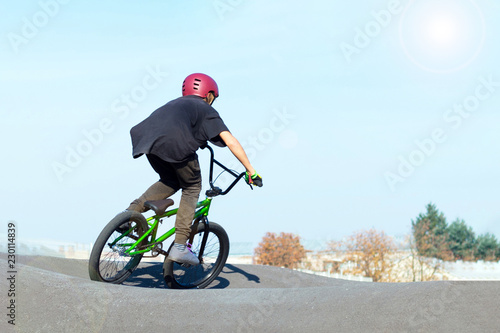 Boy in bike helmet on bmx track