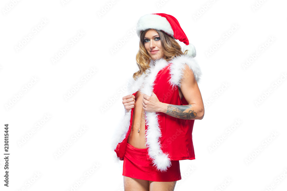 Christmas. Beautiful muscular sexual happy woman in Santa Claus clothes. Isolated on white background. Christmas. Beautiful muscular sexual happy woman in Santa Claus clothes. Isolated on white background.