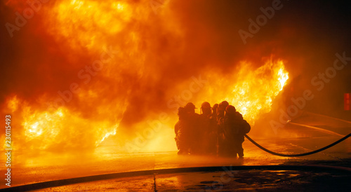 JOHANNESBURG, SOUTH AFRICA - OCTOBER, 2018 Firefighters spraying down fire during firefighting training exercise