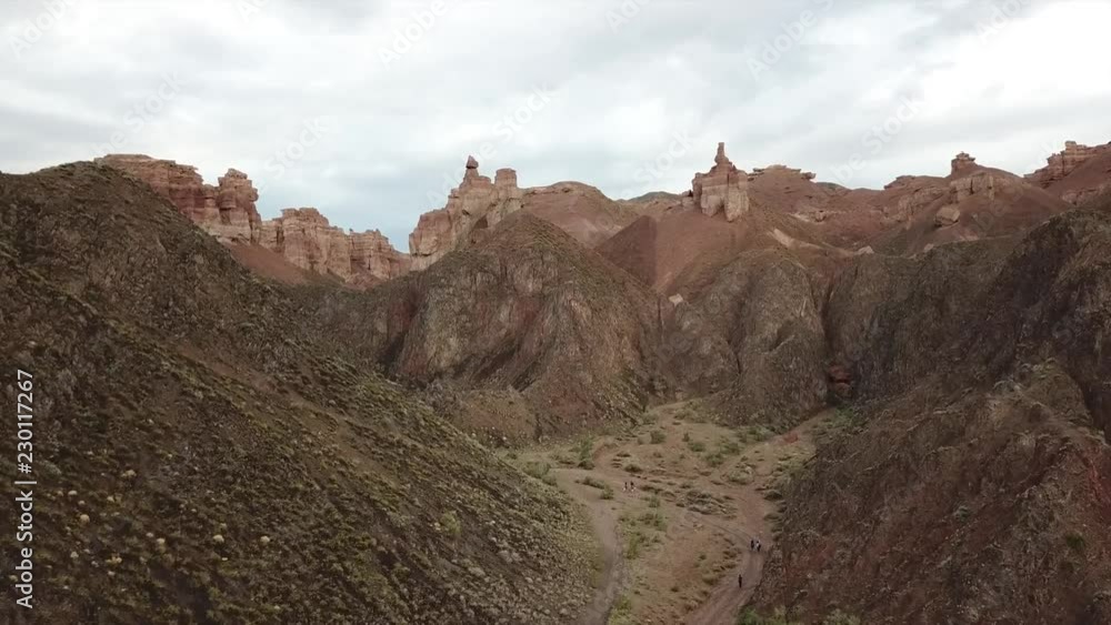 Shooting from a drone, top view of Charyn canyon. Red canyon, Martian view. Sandy and stone edge of the canyon. Breaks down. Nature Of Kazakhstan. The Grand canyon amongst the wilderness. Gray clouds Shooting from a drone, top view of Charyn canyon. Red canyon, Martian view. Sandy and stone edge of the canyon. Breaks down. Nature Of Kazakhstan. The Grand canyon amongst the wilderness. Gray clouds
