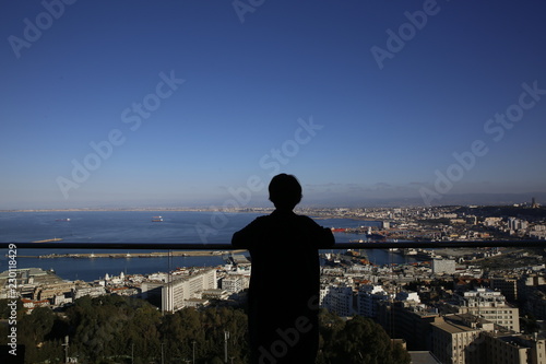 Silhouette of girl overlooking the city of Algiers, Algeria