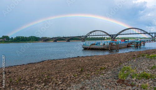 Rybinsk, Yaroslavl region, Russia, August 03, 2013: View from embankment on bridge over Volga river and rainbow 