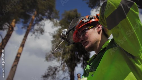 arborist wears a protective helmet and goggles