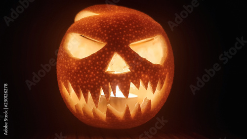Handmade halloween pumpkin scary smile on dark background
