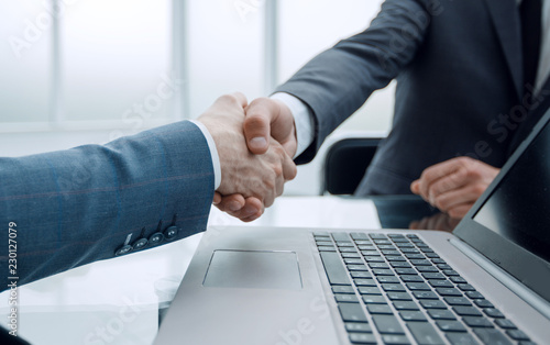 close up.business people shaking hands with each other, sitting  photo
