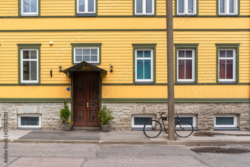 Tallinn in Estonia, wooden colorful houses, typical facades in Kalamaja, with a bike
