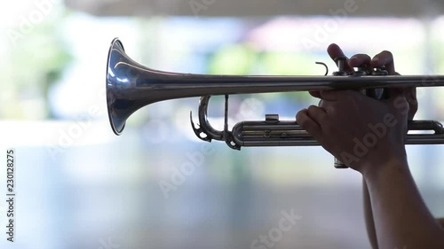 Hands of man pushing button and holding on brazen trumpet close up. Fingers of man pushing button on trumpet close up.