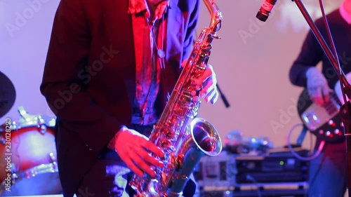 Saxophone player in jazz band performing on stage at holiday concert