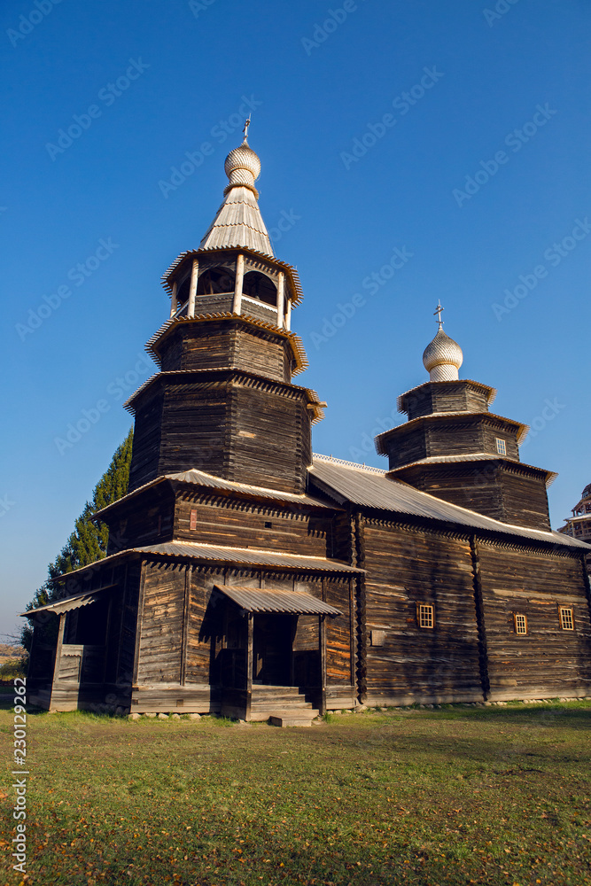 large old log Church in a village in Russia in autumn