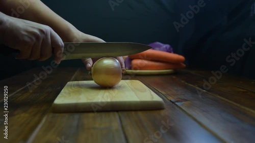 Onion cut Shooting on the detail of the onion cut. Outting onion on Wooden Board.