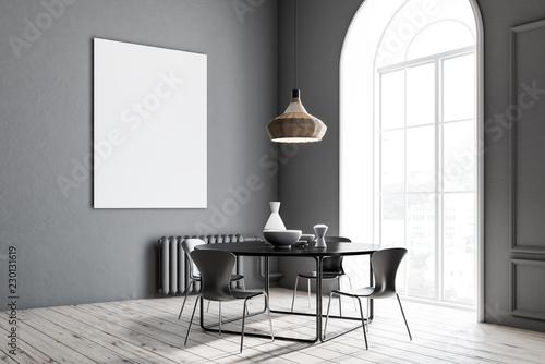 Gray dining room corner, black table, poster