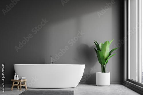 White tub in gray bathroom interior