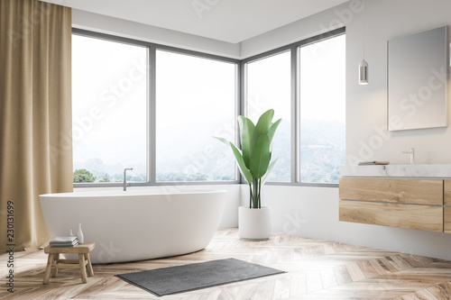 Corner of white bathroom  tub and sink