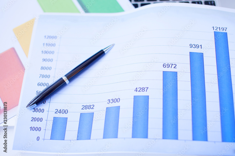 financial graph chart with notebook and black pen and keyboard. business concept financial graph chart with notebook and black pen and keyboard. business concept