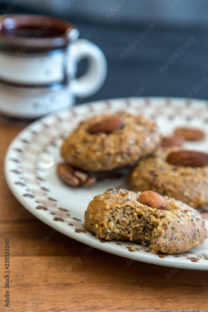 Almond Cookies on a plate with a cup of coffee