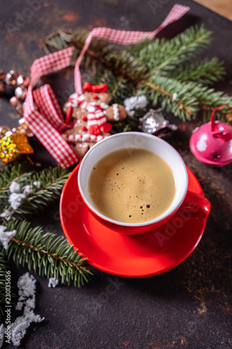 Coffee espresso, red cup of coffee and Christmas decorations on dark background.