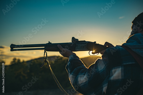 Hunting gun. Hunting without borders. Hunter with shotgun gun on hunt. Calibers of hunting rifles. Track down.