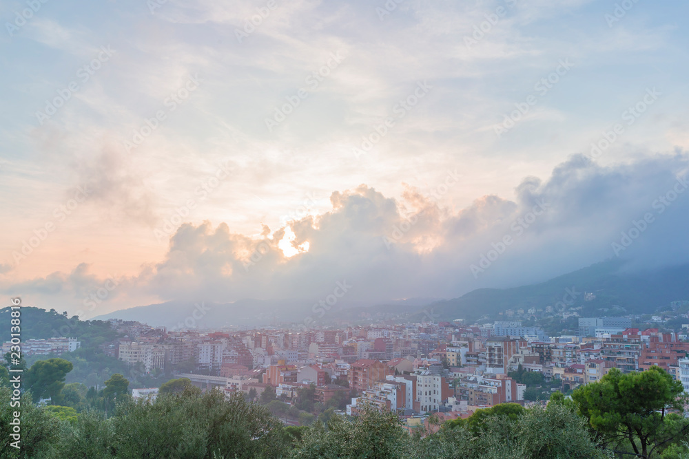 Obraz premium Barcelona view from Guell park sunset cloudy sky