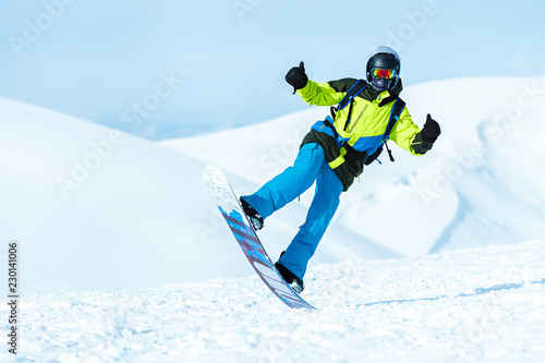 Extreme snowboard rider posing in the mountains