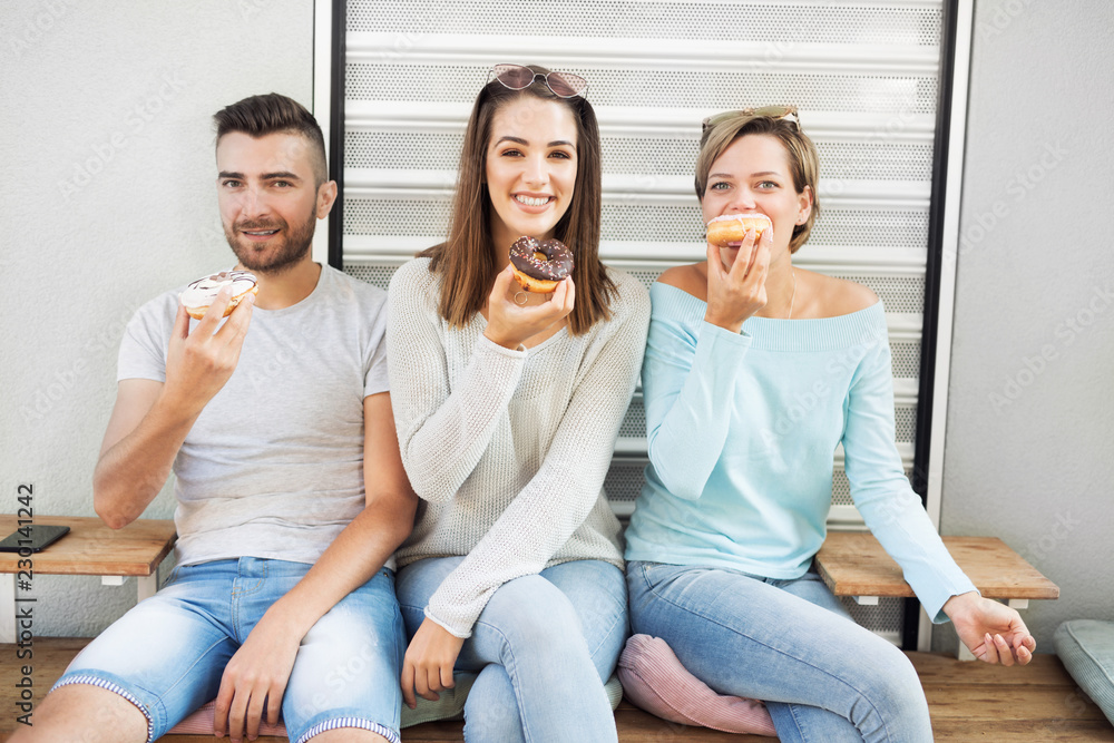 Friends eating donuts