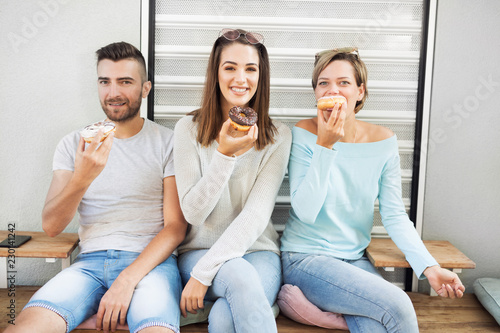 Friends eating donuts