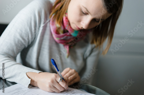 young woman writing papers