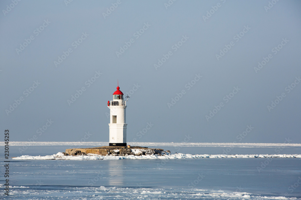 Aerial winter view of the Tokarevskiy lighthouse - one of the oldest lighthouses in the Far East, still an important navigational structure and popular attractions of Vladivostok city, Russia.	