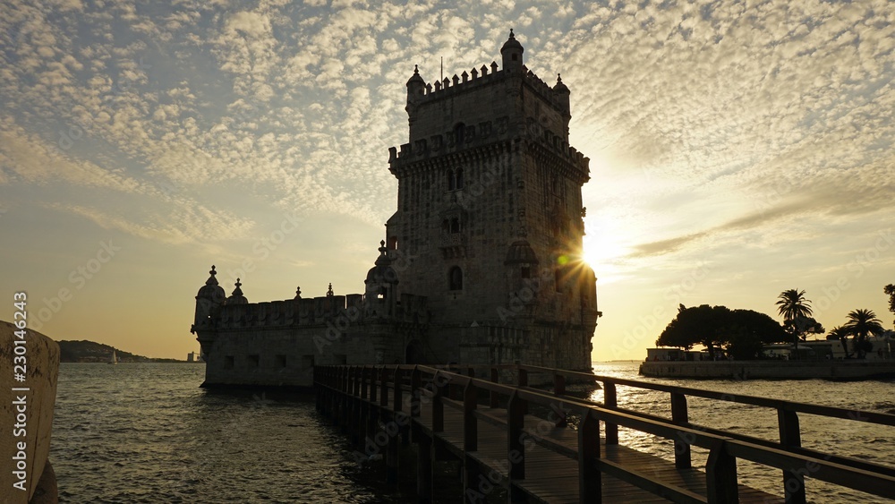 sunset at the tower of belem in lisbon