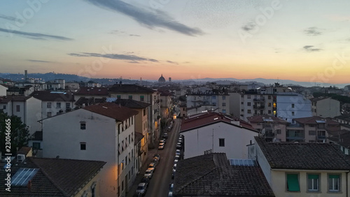 Firenze, Italy, cityscape with a road in perspective and the dome of Brunelleschi in the background, at dusk