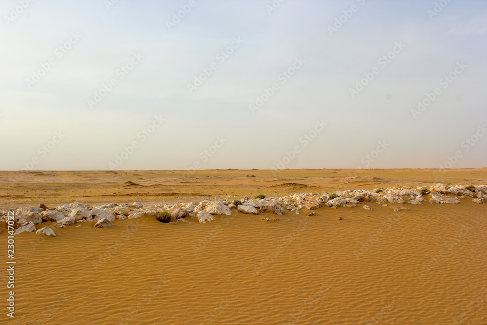 Desert sand and, rocks line under sunlight. Desert sand and, rocks line under sunlight.
