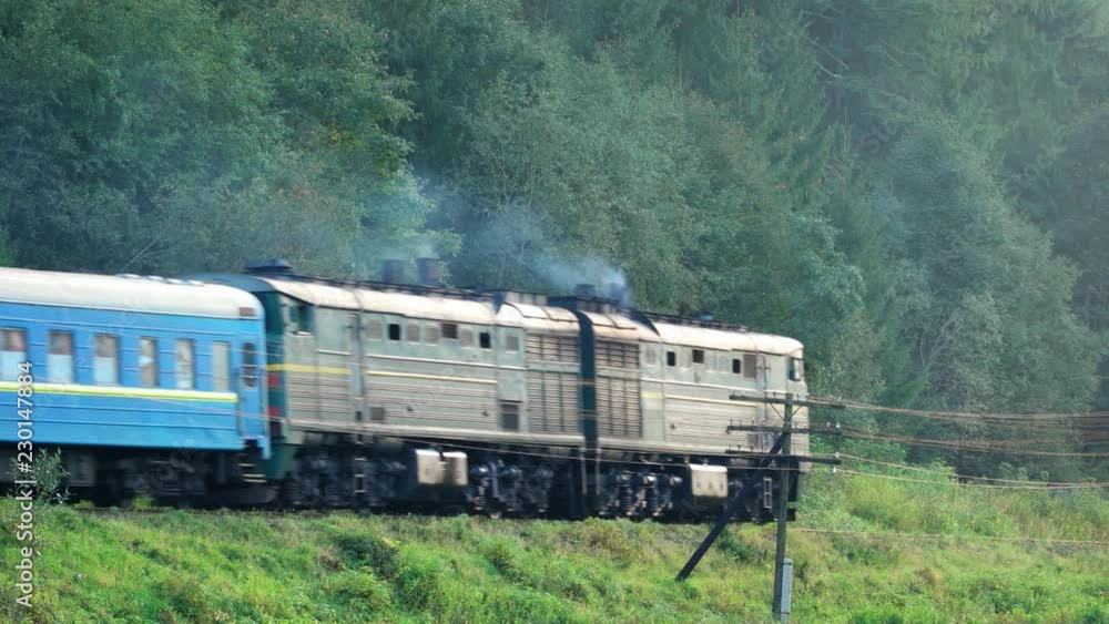 Passenger Train with Diesel Locomotive Passes through Ukrainian Countryside
