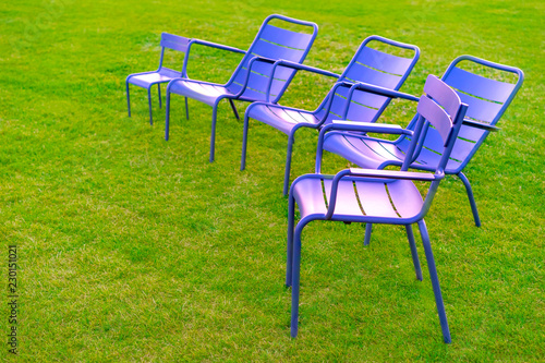 Chairs stand on the grass. ...