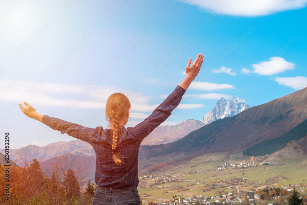 Beautiful girl with raised arms to the mountains of Svaneti, mountain Ushba, relax while traveling Beautiful girl with raised arms to the mountains of Svaneti, mountain Ushba, relax while traveling