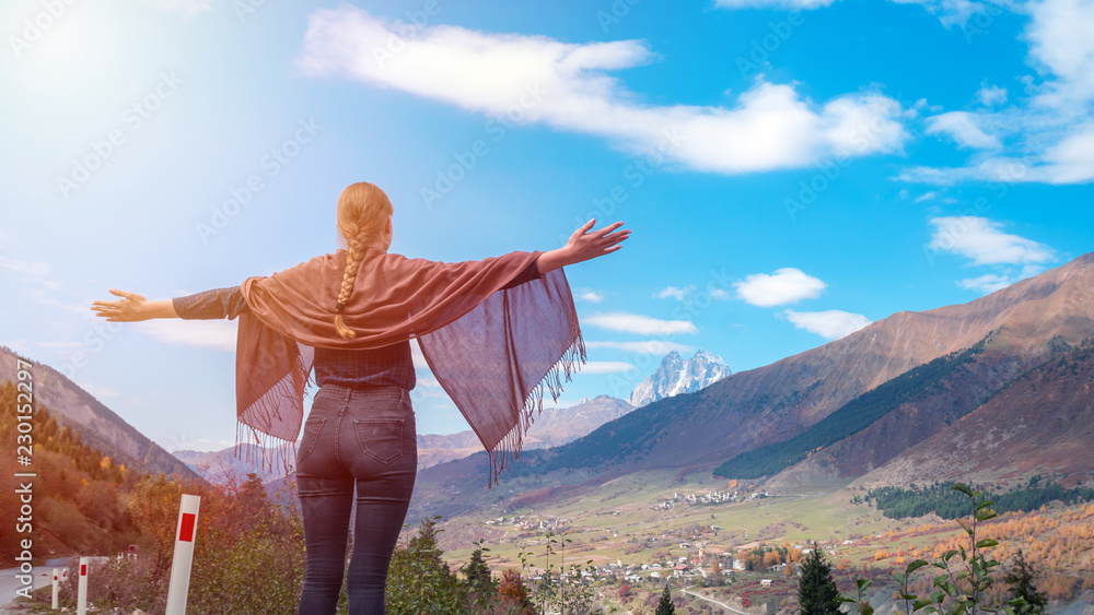 Beautiful girl with raised arms to the mountains of Svaneti, mountain Ushba, relax while traveling Beautiful girl with raised arms to the mountains of Svaneti, mountain Ushba, relax while traveling