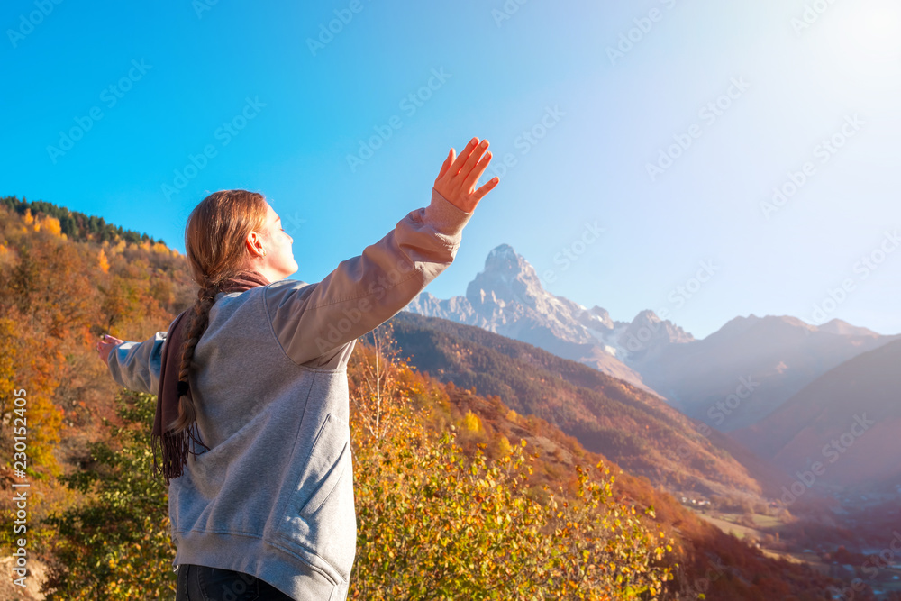 Beautiful girl with raised arms to the mountains of Svaneti, mountain Ushba, relax while traveling Beautiful girl with raised arms to the mountains of Svaneti, mountain Ushba, relax while traveling