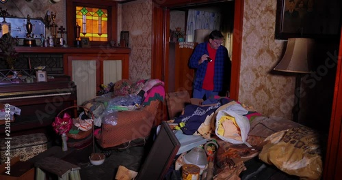 A hypothetical scene of an antique hunter picking through the living room of an old abandoned home.  	