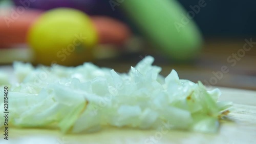 onion cut into pieces on a wooden board. Stop Motion Animation 4K.
