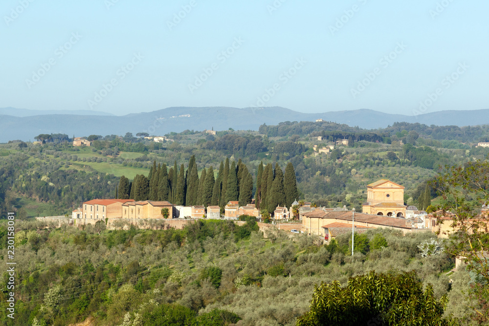 Village in the Tuscan countryside as seen from Siena, Italy, located in Tuscany 