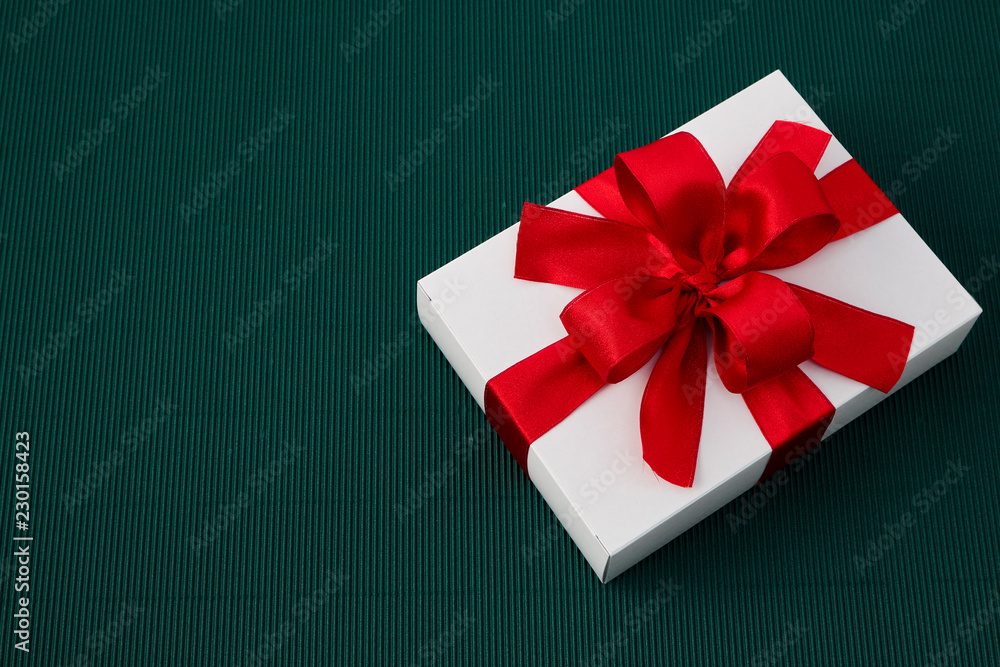 Gift Box with Ribbon on green paper Gift Box with Ribbon on green paper