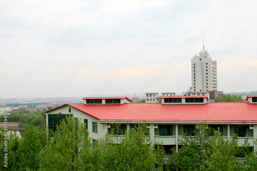 red-roofed buildings in a park red-roofed buildings in a park