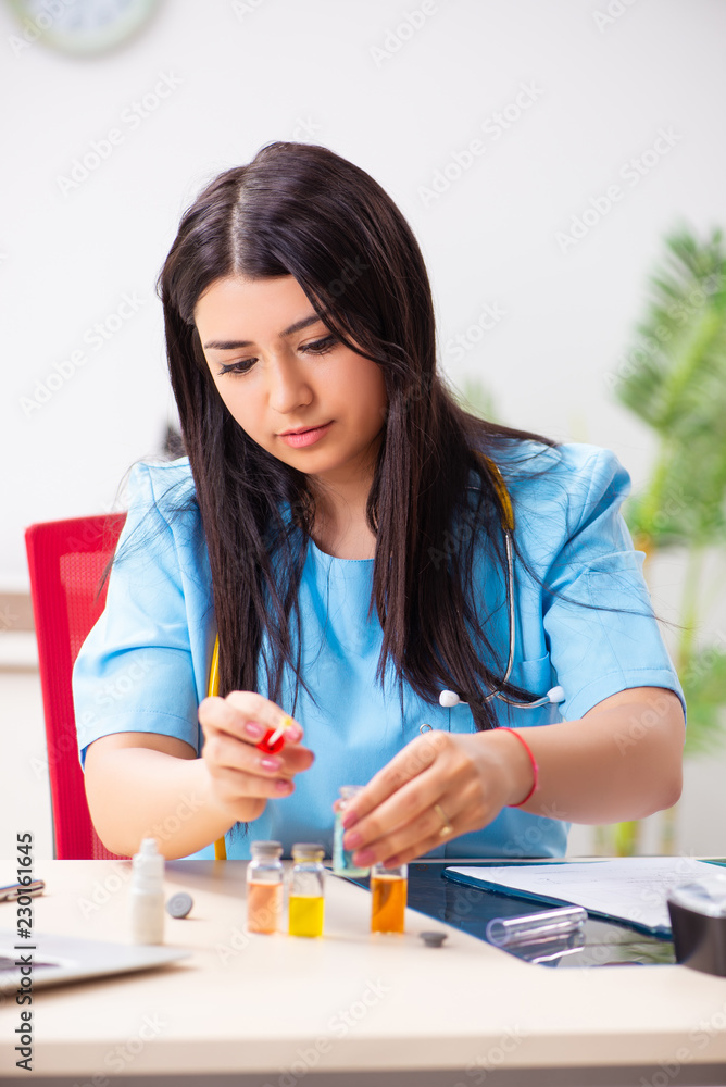 Young beautiful female doctor working in the clinic Young beautiful female doctor working in the clinic