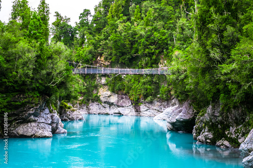 Hokitika Gorge, West Coast, New Zealand. Beautiful nature with blueturquoise color water and wooden swing bridge.