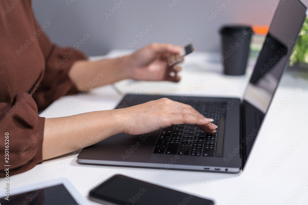 hands holding credit card and using laptop for online shopping hands holding credit card and using laptop for online shopping