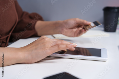hands holding digital tablet and using laptop for online shopping