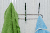 two towels blue and green on a hanger